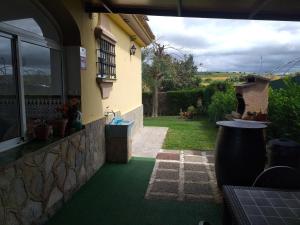 an outside view of a house with a green floor at Casa La Laguneta in Arcos de la Frontera