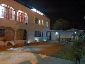 a house with a patio at night at APARTAMENTOS IPAP LUPERON in Puerto de Luperon