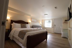 a bedroom with a large bed and a window at Victoria Gorge Waterway Vacation Home in Victoria +8 photos