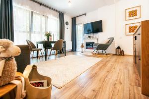 a living room with a table and chairs at Ama Apartament - Cota 1000 Sinaia in Sinaia
