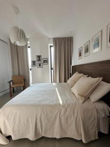 a bedroom with a large white bed with pillows at Vlore City Elegance Suite in Vlorë