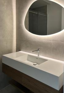 a bathroom with a white sink and a mirror at Vlore City Elegance Suite in Vlorë +41 photos