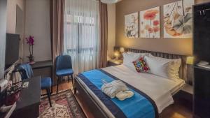 a hotel room with a bed with towels on it at Balat Side Apart in Istanbul