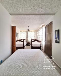a bedroom with a large bed and two windows at Hostal De Paris in Pueblo Tapao +50 photos
