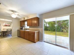 a kitchen with a large sliding glass door to a yard at Cozy 4 Bedroom Home On Merritt Island in Merritt Island