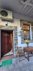 a house with a door and a table and a window at Retro apartament in Arad +23 photos