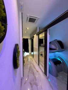 a room with purple walls and a hallway with mirrors at Metro Bengasi sotto casa, Turin top in Moncalieri