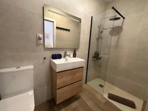 a bathroom with a sink and a shower at Apartamentos Matilda Conil - Playa in Conil de la Frontera +37 photos