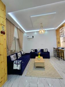 a living room with a blue couch and a table at La Marine Tabarka in Tabarka +138 photos