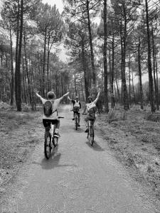 a group of people riding bikes down a trail at L'appartement près de la source in Mimizan-Plage