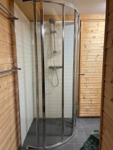 a shower with a glass door in a bathroom at Kristiansund Airport Motell in Kristiansund +47 photos