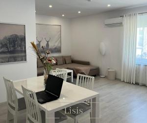 a living room with a table with a laptop on it at Lisis Premium Apartments in Reşiţa