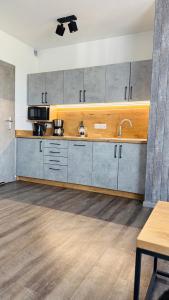 a kitchen with a sink and a counter top at Apartament Holiday Grey in Rewal