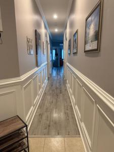 a hallway with white walls and a wooden bench at First Class Treatment Luxurious end unit Patio Pool Restaurant Bar on premises Steps away from Everything else! Spacious Condo Stocked with all You Need! in Myrtle Beach +104 photos