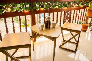 a table and two chairs on a balcony at Blomst Casa Hostal in Jericó