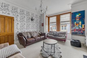 a living room with a couch and a table at Large 4 Bed Town House Ideal for Contractors & Family Friendly in Great Central Location in Plymouth