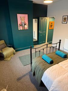 a bedroom with a bed with blue pillows on it at winslow in Manchester