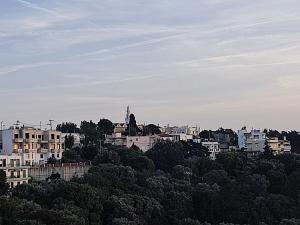a city skyline with buildings on a hill at Anemomilos View in Koskinou