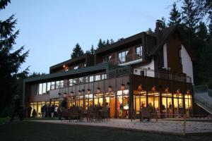 a large building with people standing outside of it at Hotel Rakitna in Rakitna