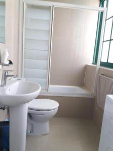 a bathroom with a toilet and a sink and a tub at TUNERAS SUNSET Puerto Rico Apartment, Sea view, Pool, Perfect for sun lovers in Mogán +27 photos