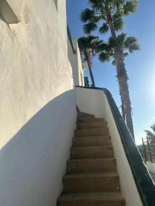 a staircase leading up to a building with palm trees at TUNERAS SUNSET Puerto Rico Apartment, Sea view, Pool, Perfect for sun lovers in Mogán