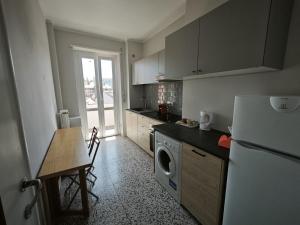 cocina con nevera blanca y mesa con mesa en Casa Augusta, en Milán