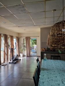 a dining room with a table and chairs and windows at Quinta Benavidez in Benavídez
