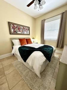a bedroom with a large bed and a window at Heart of Hyde Park Tampa/Parking/Netflix/Gym in Tampa