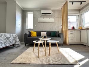 a living room with a couch and two tables at Apartment 'Avlija' in Mostar