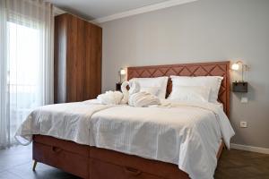 a bedroom with a large bed with towels on it at Luxury rooms Iva in Zadar