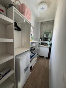 a kitchen with white cabinets and a refrigerator at Room Mayi GC in Las Palmas de Gran Canaria
