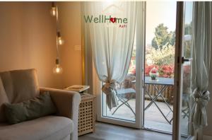 a living room with a couch and a sliding glass door at WellHome in Asti