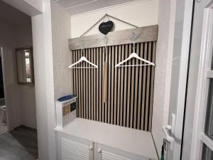 a room with a white wall with a closet at Bungalow-32-100-Schritte-bis-zum-Meer in Staberdorf +14 photos