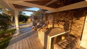 a screened in porch with a couch on a wooden deck at Les Granges in Vigoulant