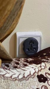 a digital alarm clock on top of a bed at Cozy Apartment Near Rabat & Beach in Temara +34 photos