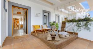 a room with a porch with chairs and a table at Burgau Charming House Villa in Burgau