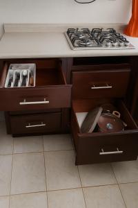 a kitchen with a stove and some drawers at House with pool, near the beach - Casa con alberca, cerca de playa in Mazatlán