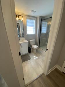 a bathroom with a toilet and a sink and a shower at Guest Suite in Ottawa in Ottawa