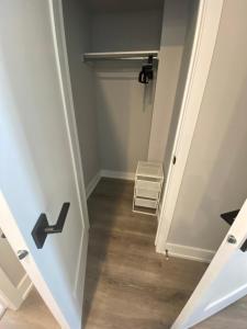 a hallway with a staircase with a door and a stool at Guest Suite in Ottawa in Ottawa