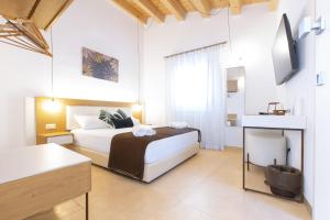 a bedroom with a bed and a television in it at Bed and Breakfast Nilu' in Castellammare del Golfo