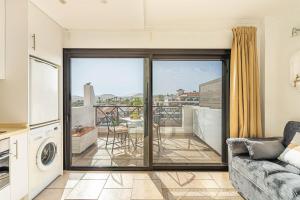 a living room with a couch and a balcony at As de Casas - Parque Albatros 2 in San Miguel de Abona