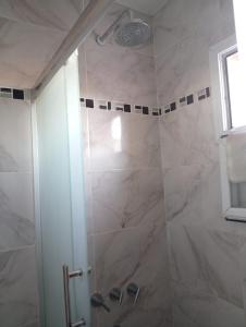 a bathroom with a shower with a glass door at La Casita in Olavarría