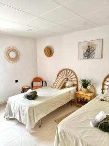 a bedroom with two beds and a mirror at Serena Villa in Benicarló