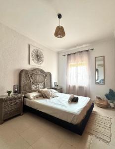 a bedroom with a large bed and a clock on the wall at Serena Villa in Benicarló +43 photos
