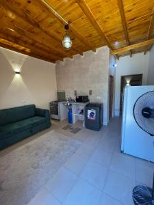 a living room with a couch and a refrigerator at Family House in Dahab