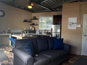 a living room with a couch and a kitchen at Cozy Comfy Budget Friendly in San Fernando