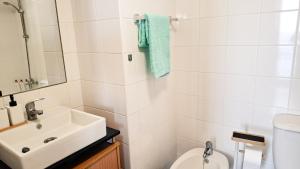 a white bathroom with a sink and a toilet at Mãe de Deus - Caniço - Madeira in Caniço +41 photos