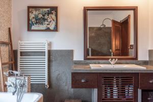 a bathroom with a sink and a mirror at Sintra - Praia Grande Village in Colares +72 photos