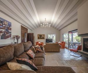 a living room with a couch and a fireplace at Sintra - Praia Grande Village in Colares
