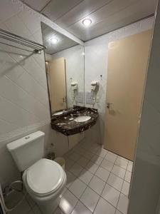 a bathroom with a toilet and a sink at Hotel Mercu Privi Moema Ibirapuera com ar e piscina 1810 in Sao Paulo